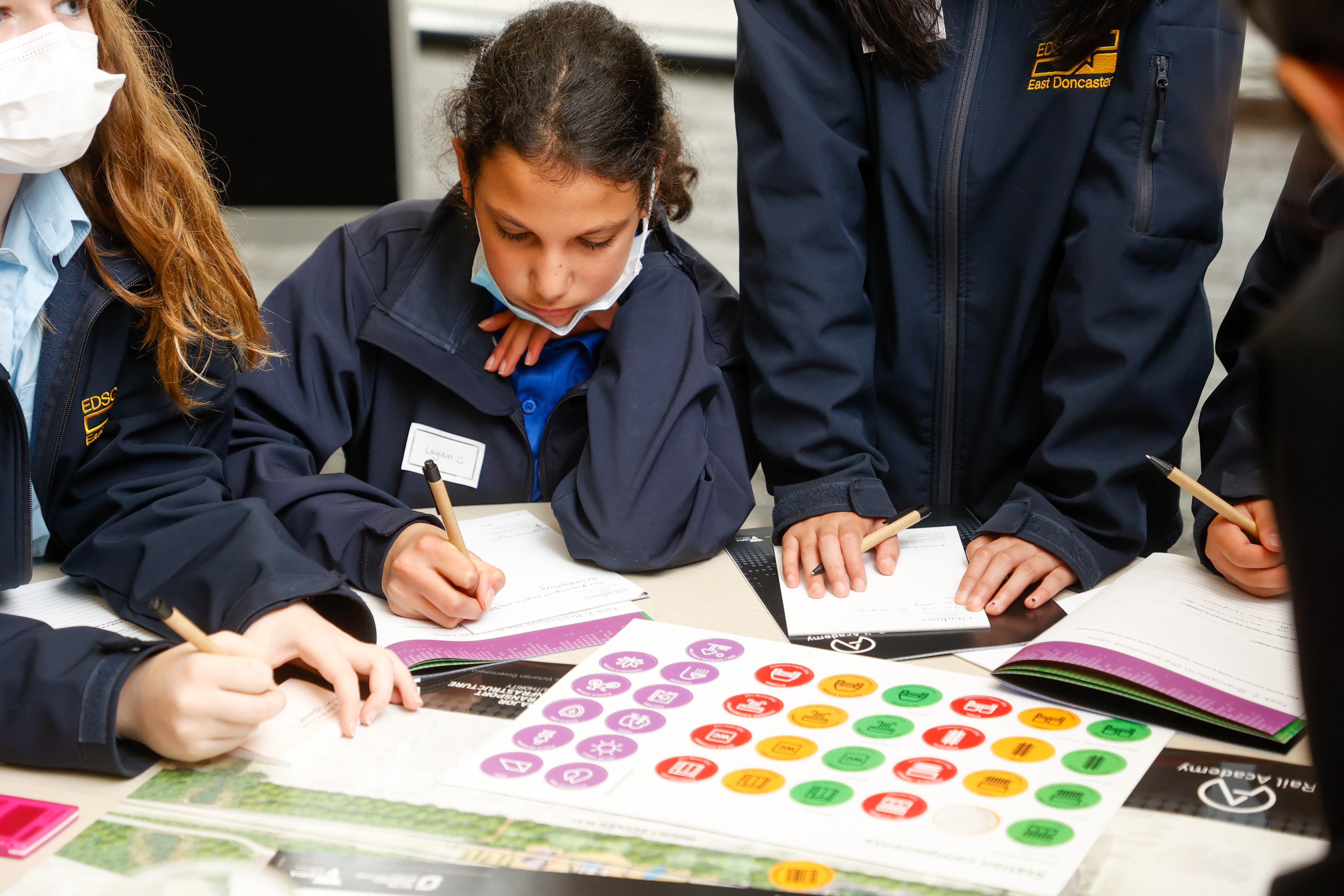 Four school students from year 9 at East Doncaster work through the design your own station at a STEMinist event.